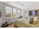 Light bedroom with yellow bedding, wood floors, and large windows offering tree views at 3305 Knot Aly, Johns Island, SC 29455
