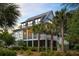 Beautiful two-story home featuring a screened porch, metal roof, and surrounded by tropical landscaping at 3305 Knot Aly, Johns Island, SC 29455