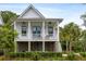 Charming two-story home with a covered porch, white picket railings and well-manicured landscaping at 3305 Knot Aly, Johns Island, SC 29455