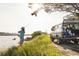 Peaceful scene of a person fishing by the lake with a loyal dog watching from the back of their car at 3305 Knot Aly, Johns Island, SC 29455