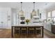 Modern kitchen with white cabinets, a marble island with seating, and stainless steel appliances at 3305 Knot Aly, Johns Island, SC 29455