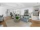 Bright living room with hardwood floors, a modern ceiling fan, and seamless flow into the kitchen at 3305 Knot Aly, Johns Island, SC 29455