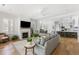 Open-concept living room featuring a fireplace, hardwood floors, and seamless flow into the kitchen at 3305 Knot Aly, Johns Island, SC 29455