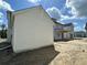 Side view of a two-story home showcasing white siding, under construction with open backyard at 337 Trailmore Ln, Summerville, SC 29486