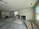 Unfinished living room featuring a cozy fireplace and lots of natural light from the windows at 337 Trailmore Ln, Summerville, SC 29486