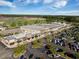 Aerial view of a busy commercial building with ample parking, set against a backdrop of lush greenery at 342 Saxony Loop, Summerville, SC 29486