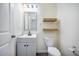Clean and bright bathroom with modern vanity, toilet, floating shelves, and minimalist design at 342 Saxony Loop, Summerville, SC 29486