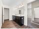 Bathroom with double sinks, dark cabinets, and wood-look flooring at 342 Saxony Loop, Summerville, SC 29486