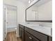 Bright bathroom features double sinks, wood-look floors, and a large vanity mirror at 342 Saxony Loop, Summerville, SC 29486