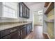 Walk-in pantry with granite countertop, cabinets, and open shelving for organized storage at 342 Saxony Loop, Summerville, SC 29486