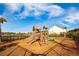 A community playground with a wooden playset and a partially fenced in area for safety at 342 Saxony Loop, Summerville, SC 29486