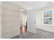 This walk-in closet features built in shelving with access to a doorway and a sunlit window at 342 Saxony Loop, Summerville, SC 29486