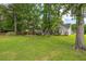 Expansive lawn area with mature trees and the rear exterior view of the house at 420 Manorwood Ln, Charleston, SC 29414
