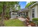 Backyard featuring a screened in porch, stone patio and lush landscaping at 420 Manorwood Ln, Charleston, SC 29414
