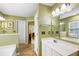 Bathroom with white vanity, large mirror, tub with tile surround, and neutral flooring at 420 Manorwood Ln, Charleston, SC 29414