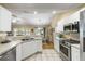 Modern kitchen with white cabinetry, stainless steel appliances, and a view to dining area at 420 Manorwood Ln, Charleston, SC 29414