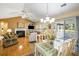 A spacious living area featuring vaulted ceilings and seamless access to outdoor screened porch at 420 Manorwood Ln, Charleston, SC 29414