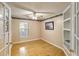 Empty office with a ceiling fan, a window, built-in shelves, and light colored walls at 420 Manorwood Ln, Charleston, SC 29414