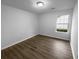 This empty bedroom features hard wood floors, and a bright, well lit window at 4500 Winterwood Pl, Ladson, SC 29456