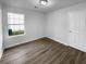 This empty bedroom features hard wood floors, a bright, well lit window, and closet at 4500 Winterwood Pl, Ladson, SC 29456