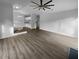 Inviting living room featuring wood floors, ceiling fan, and access to other rooms at 4500 Winterwood Pl, Ladson, SC 29456