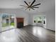 Bright living room featuring a fireplace, bay window, ceiling fan, and sliding glass doors to the backyard at 4500 Winterwood Pl, Ladson, SC 29456