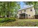Backyard view featuring a two-story home with a screened porch and lush landscaping at 5404 Red Fork Ln, North Charleston, SC 29420