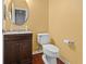 Clean half bathroom with a single sink vanity and a modern toilet at 5404 Red Fork Ln, North Charleston, SC 29420