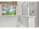 Bright bathroom featuring a soaking tub, a walk-in shower, and a window providing natural light at 5404 Red Fork Ln, North Charleston, SC 29420