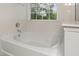 Bright bathtub area featuring a soaking tub and a window providing plenty of natural light at 5404 Red Fork Ln, North Charleston, SC 29420