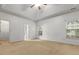 Spacious bedroom featuring natural light, a ceiling fan, neutral carpet and an attached bath at 5404 Red Fork Ln, North Charleston, SC 29420