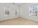 Bright carpeted bedroom showcasing natural light with multiple windows and neutral paint at 5404 Red Fork Ln, North Charleston, SC 29420