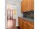 Open layout featuring kitchen cabinets, mosaic backsplash, and a view into the dining area at 5404 Red Fork Ln, North Charleston, SC 29420