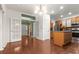 Open-concept kitchen and living area with hardwood floors and stainless steel appliances at 5404 Red Fork Ln, North Charleston, SC 29420