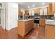 A well-equipped kitchen with an island, stainless steel appliances, and hardwood floors at 5404 Red Fork Ln, North Charleston, SC 29420