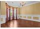 Bright living room showcasing hardwood floors, large windows, and decorative molding at 5404 Red Fork Ln, North Charleston, SC 29420