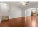 Open living area with hardwood floors, staircase, and an archway into the kitchen at 5404 Red Fork Ln, North Charleston, SC 29420