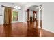 Open-concept room featuring a fireplace, hardwood floors, and sliding glass doors to a porch at 5404 Red Fork Ln, North Charleston, SC 29420