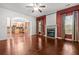 Spacious living room featuring hardwood floors, a fireplace, and an open kitchen view at 5404 Red Fork Ln, North Charleston, SC 29420