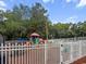 Community playground is fenced in, and offers a colorful playset, swings, and benches at 5404 Red Fork Ln, North Charleston, SC 29420