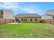 A backyard with a lush green lawn, a patio, and a wood fence at 541 Brick Barn Ln, Goose Creek, SC 29445