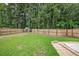 A large, verdant backyard featuring a wooden fence and mature trees for privacy at 541 Brick Barn Ln, Goose Creek, SC 29445