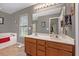 Bathroom featuring a double sink vanity, updated fixtures, a soaking tub, and tile floors at 541 Brick Barn Ln, Goose Creek, SC 29445