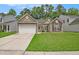 Charming single-story home features a two-car garage and well-manicured lawn in a suburban neighborhood at 541 Brick Barn Ln, Goose Creek, SC 29445