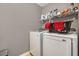 A laundry room with a front loading washer and dryer and wire shelving at 541 Brick Barn Ln, Goose Creek, SC 29445
