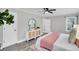Serene bedroom featuring a dresser with round mirror, ceiling fan, and ensuite bath at 718 Parish Rd, Charleston, SC 29407