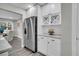 Bright kitchen features stainless steel refrigerator, white cabinets, wine rack, and a view to the dining area at 718 Parish Rd, Charleston, SC 29407