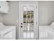 Bright laundry room with washer, dryer, and glass panel door to the backyard at 718 Parish Rd, Charleston, SC 29407