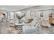 Open-concept living room with modern furnishings, view to the kitchen, and ample natural light at 718 Parish Rd, Charleston, SC 29407