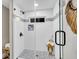Modern shower featuring glass enclosure, decorative tile accent, and a built in shower caddy at 718 Parish Rd, Charleston, SC 29407